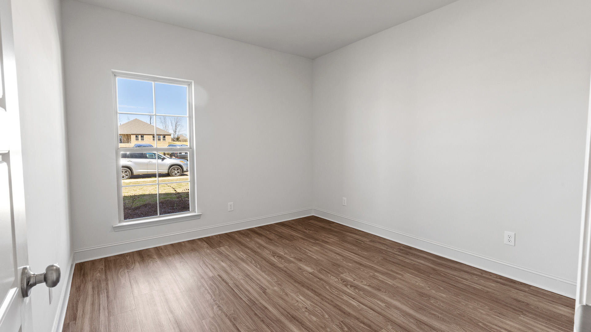 bedroom 2 with hardwood floors and window