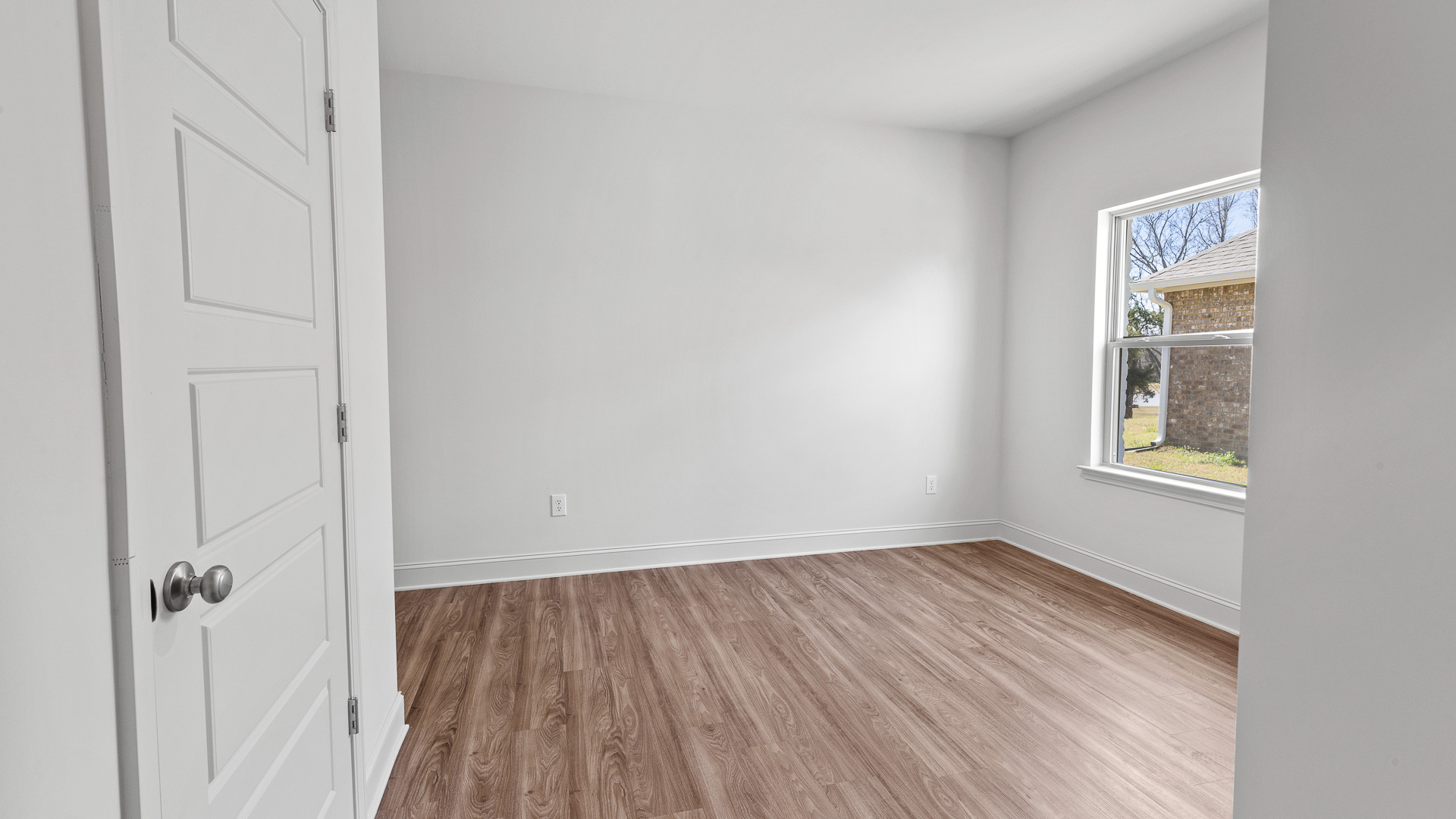 bedroom 4 with hardwood floors and window