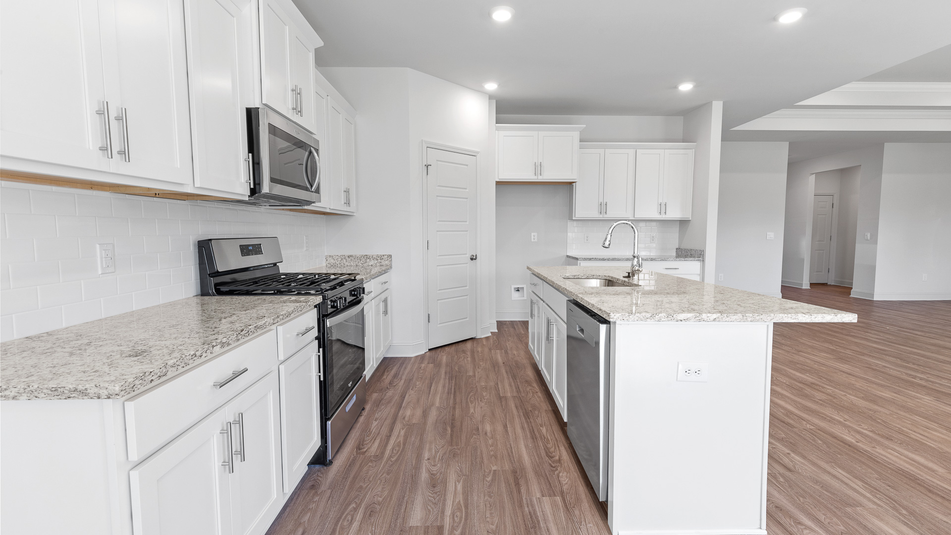open kitchen with granite countertops and stainless steel appliances