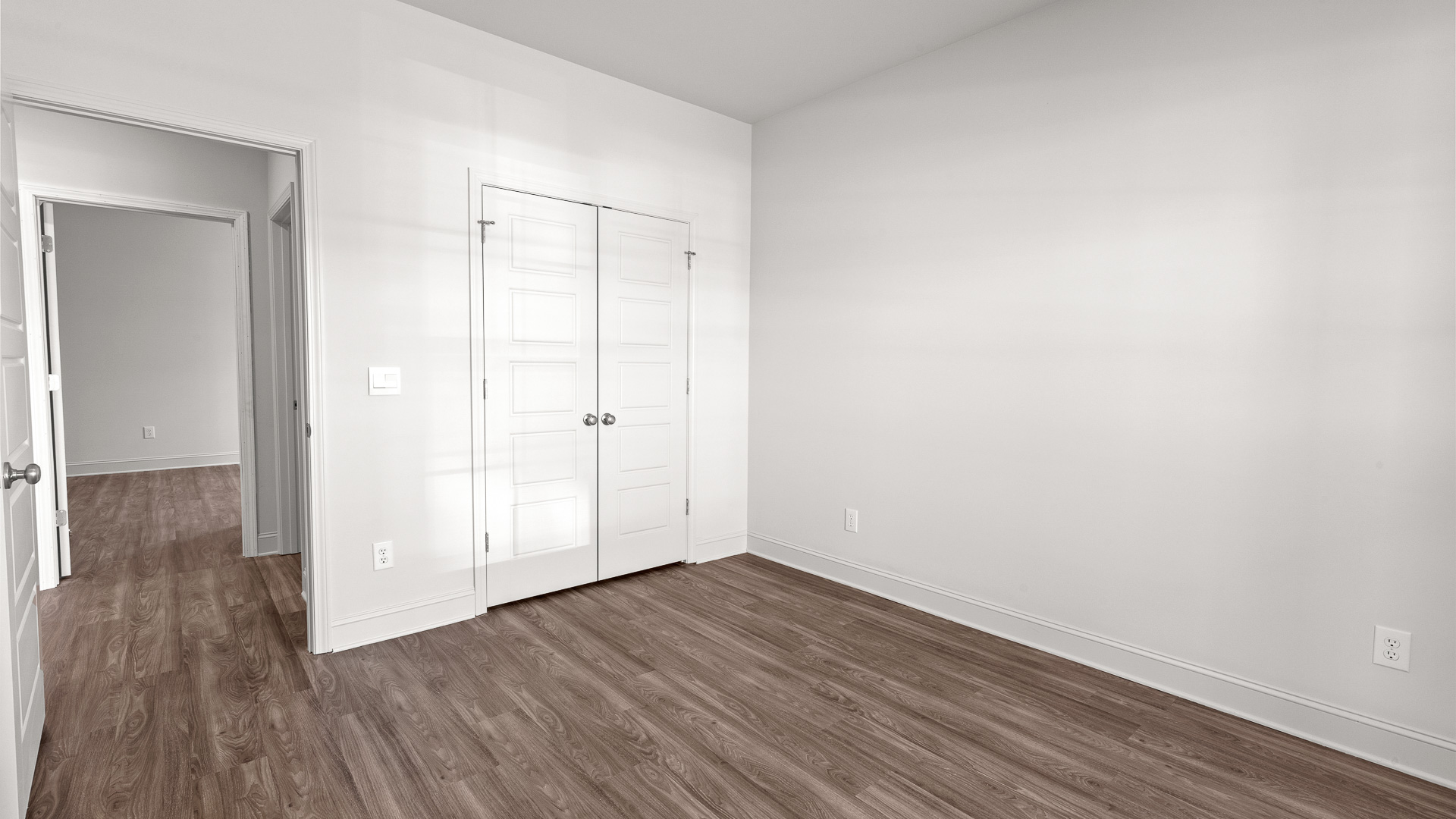 Another bedroom with hardwood floors and double door closet.