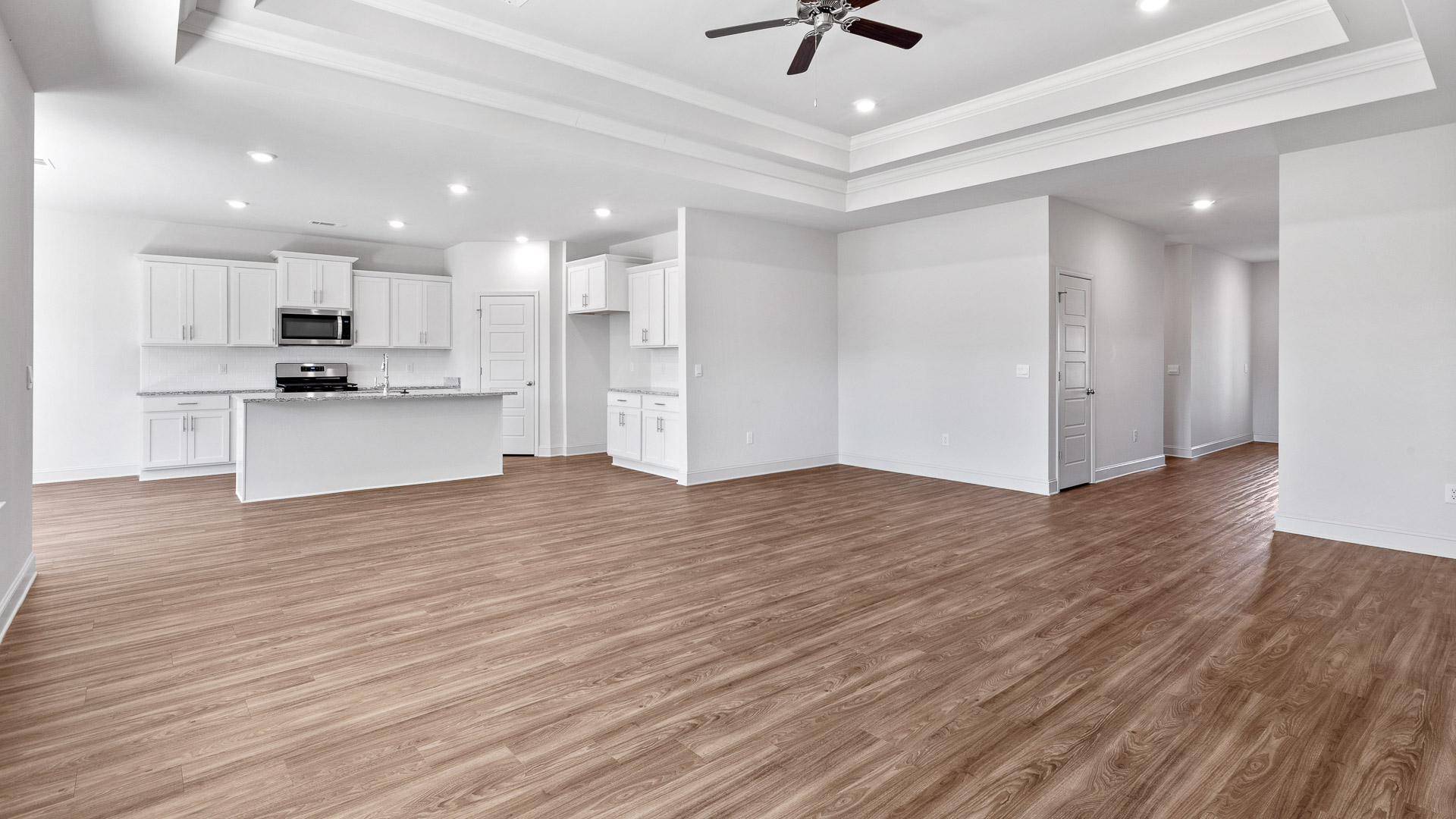 Open floor plan of the living, dining, and kitchen area.