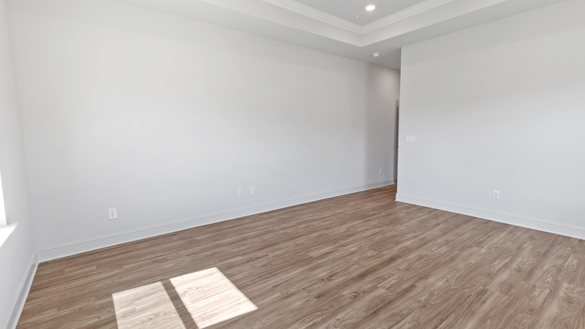 Other view of the primary bedroom with hardwood floors