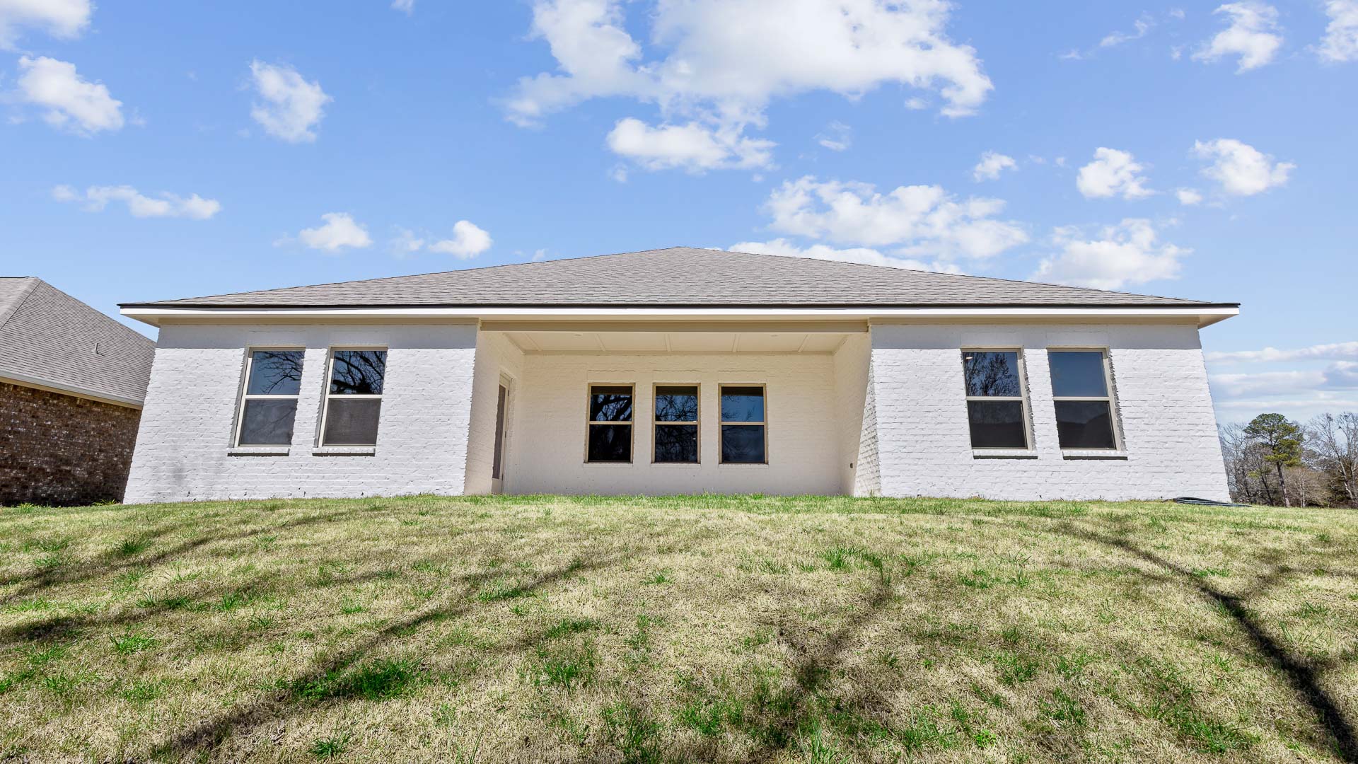 Back exterior of the covered patio opening up the backyard.