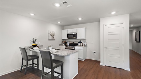 Kitchen with stainless steel appliances, shaker style cabinets, and pantry