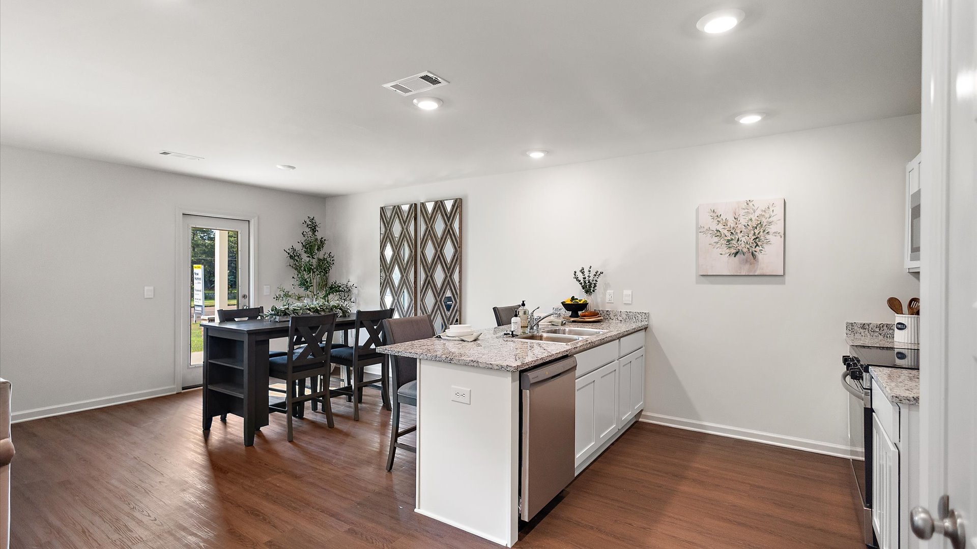 Kitchen with stainless steel appliances, shaker style cabinets, and pantry