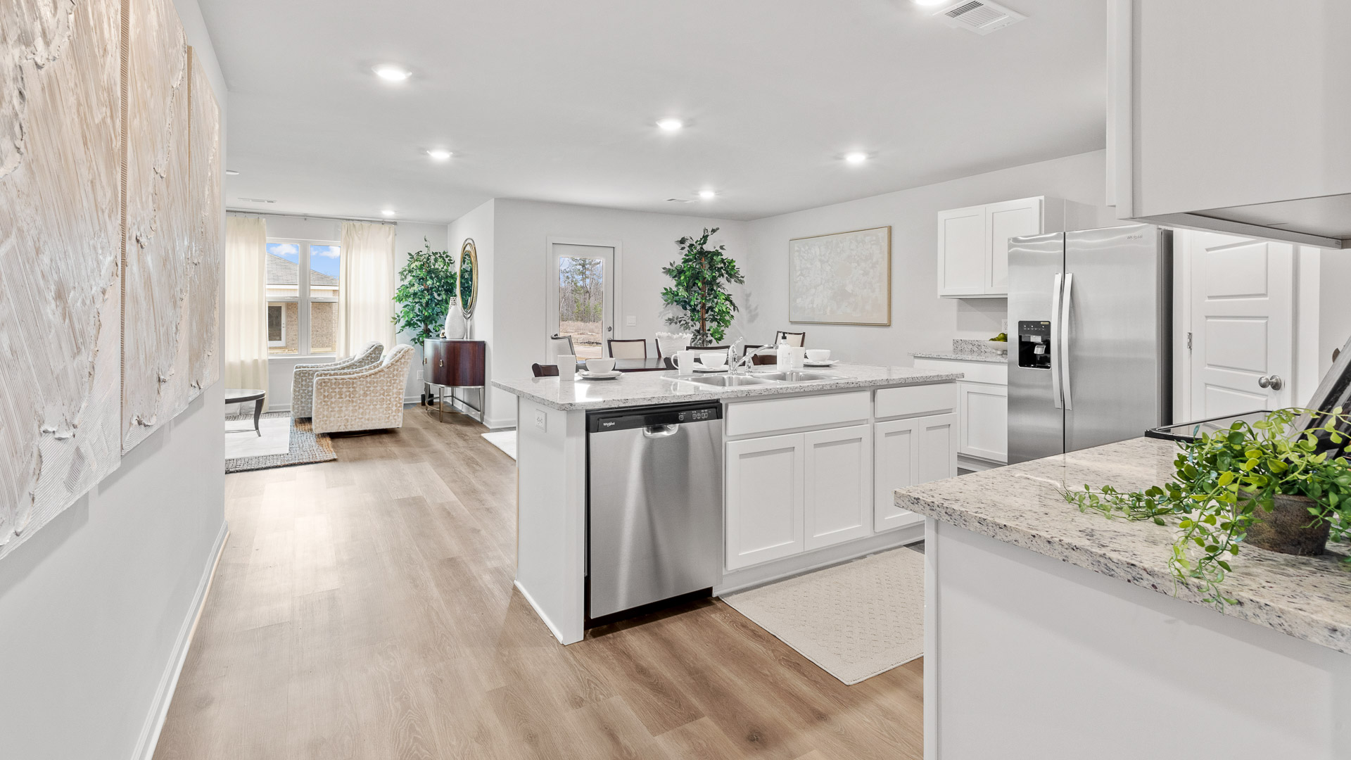 Open concept kitchen, dining room and living room view from the entrance hallway.