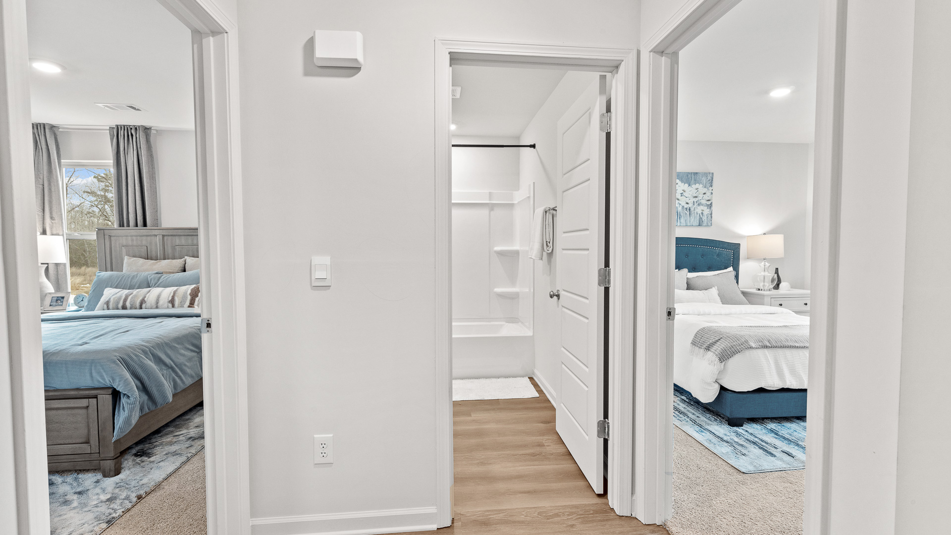 View of two bedrooms and a full hall bath from the entrance hallway.