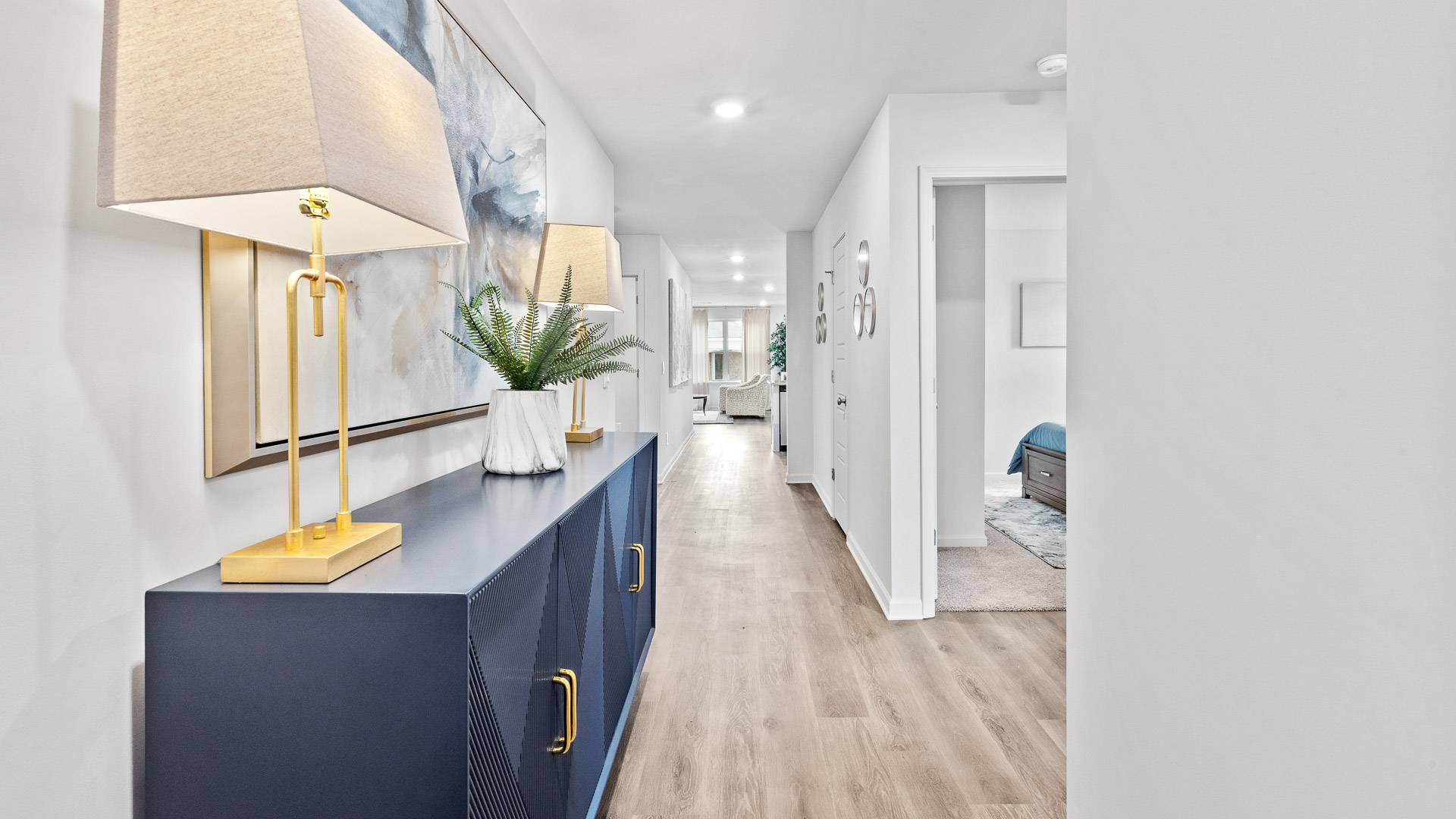 Entrance hallway with a view of the living room and a bedroom.