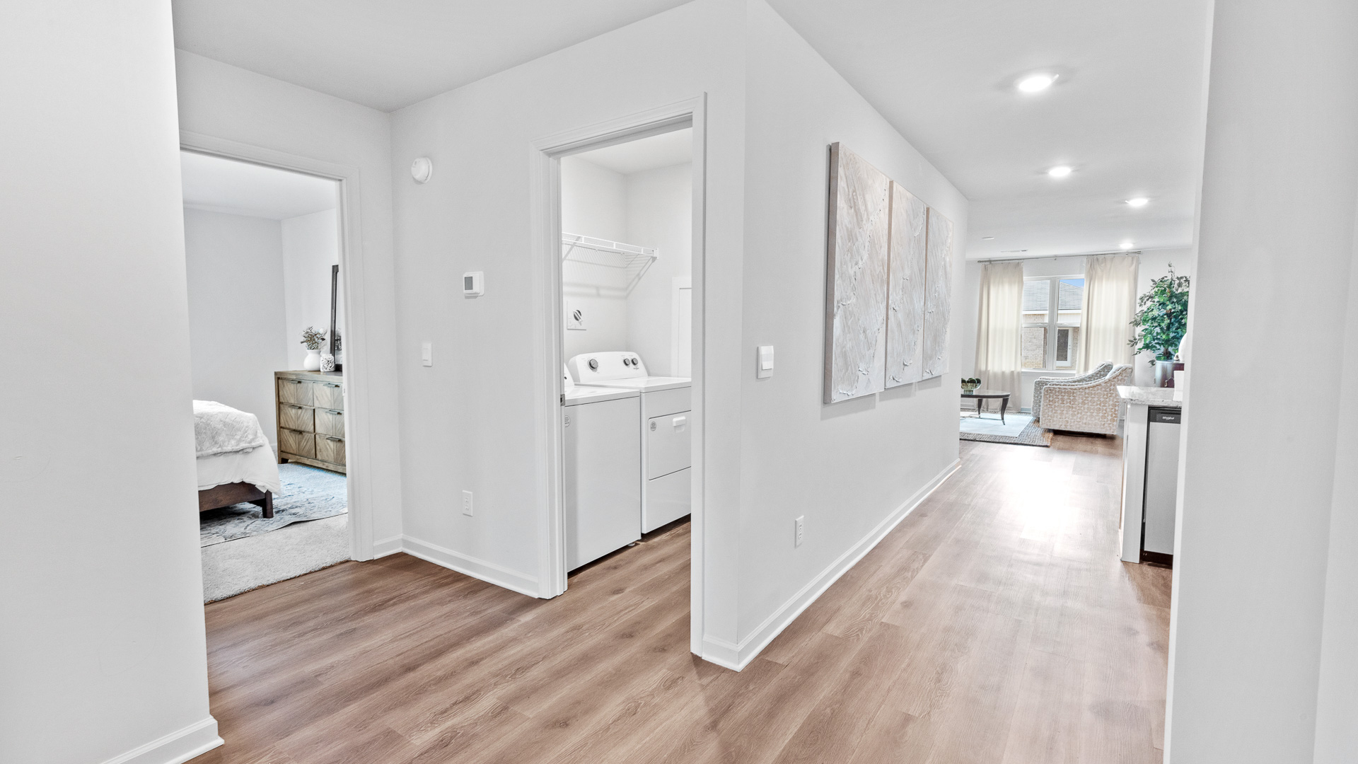 View of laundry room and bedroom 4/den from the entrance hallway.