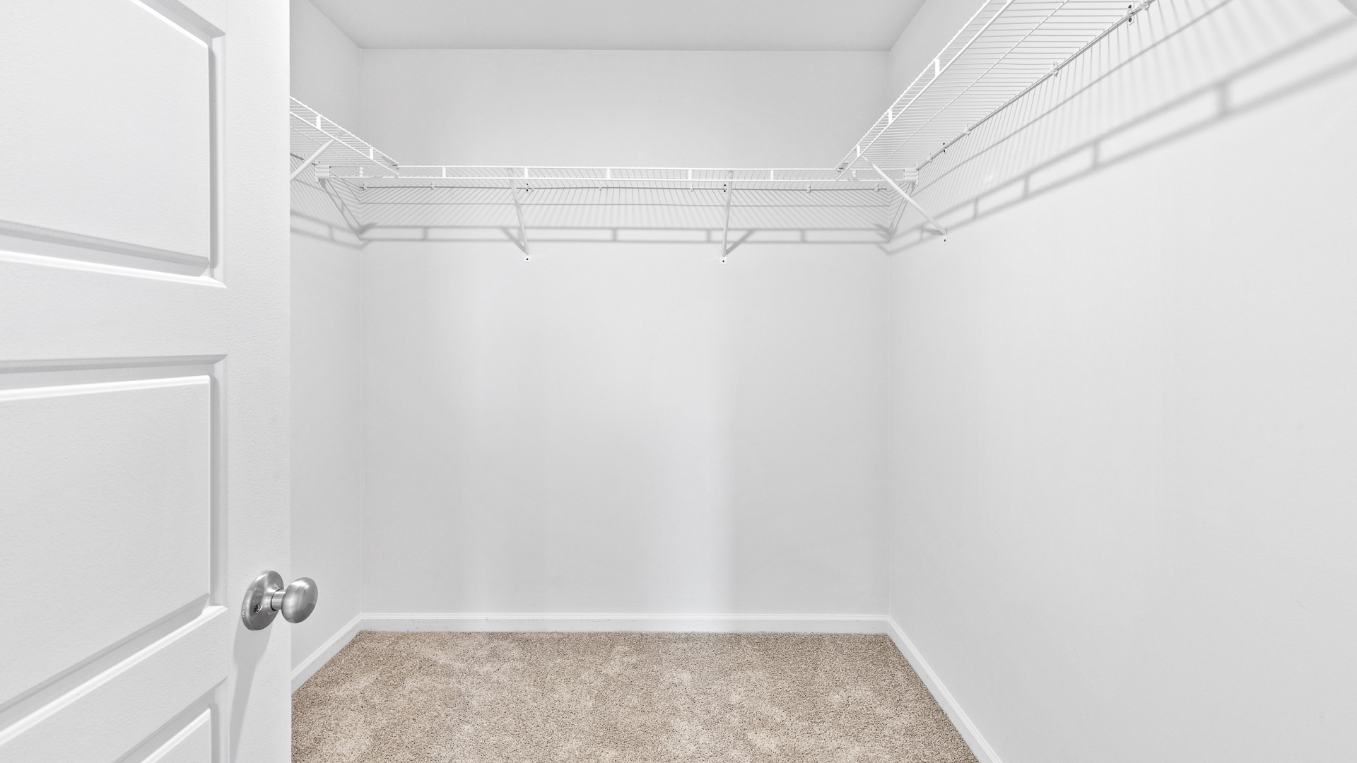 Walk-in closet in the ensuite bathroom with neutral carpet.