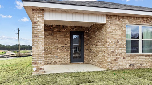 Covered back porch with a glass back door.