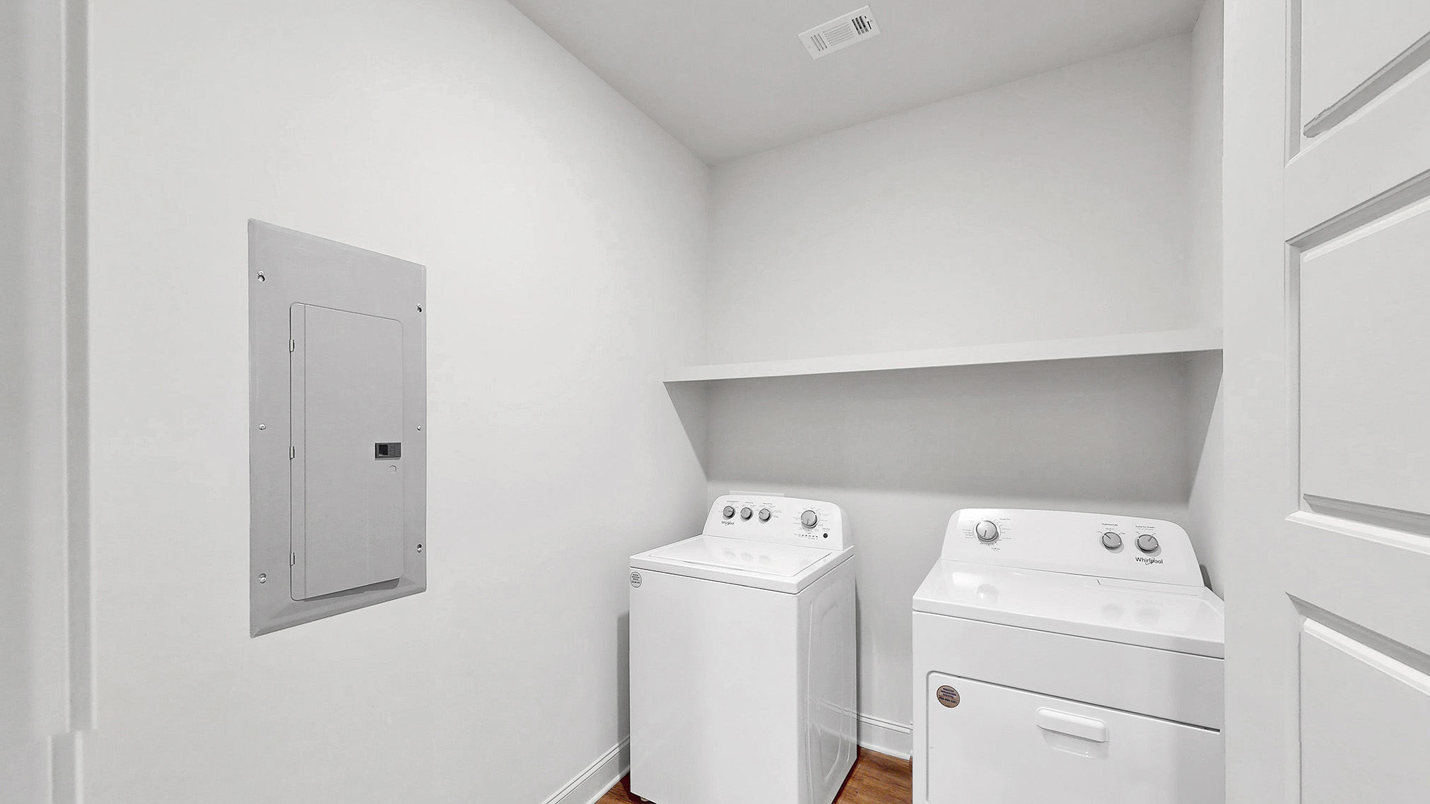 laundry space with wood shelving