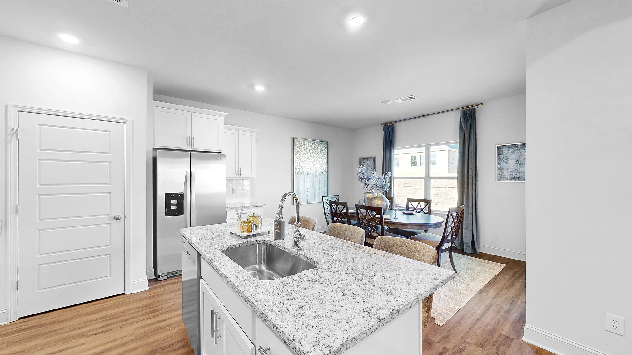 spacious kitchen with granite counters, soft close cabinets, and hardwood floors