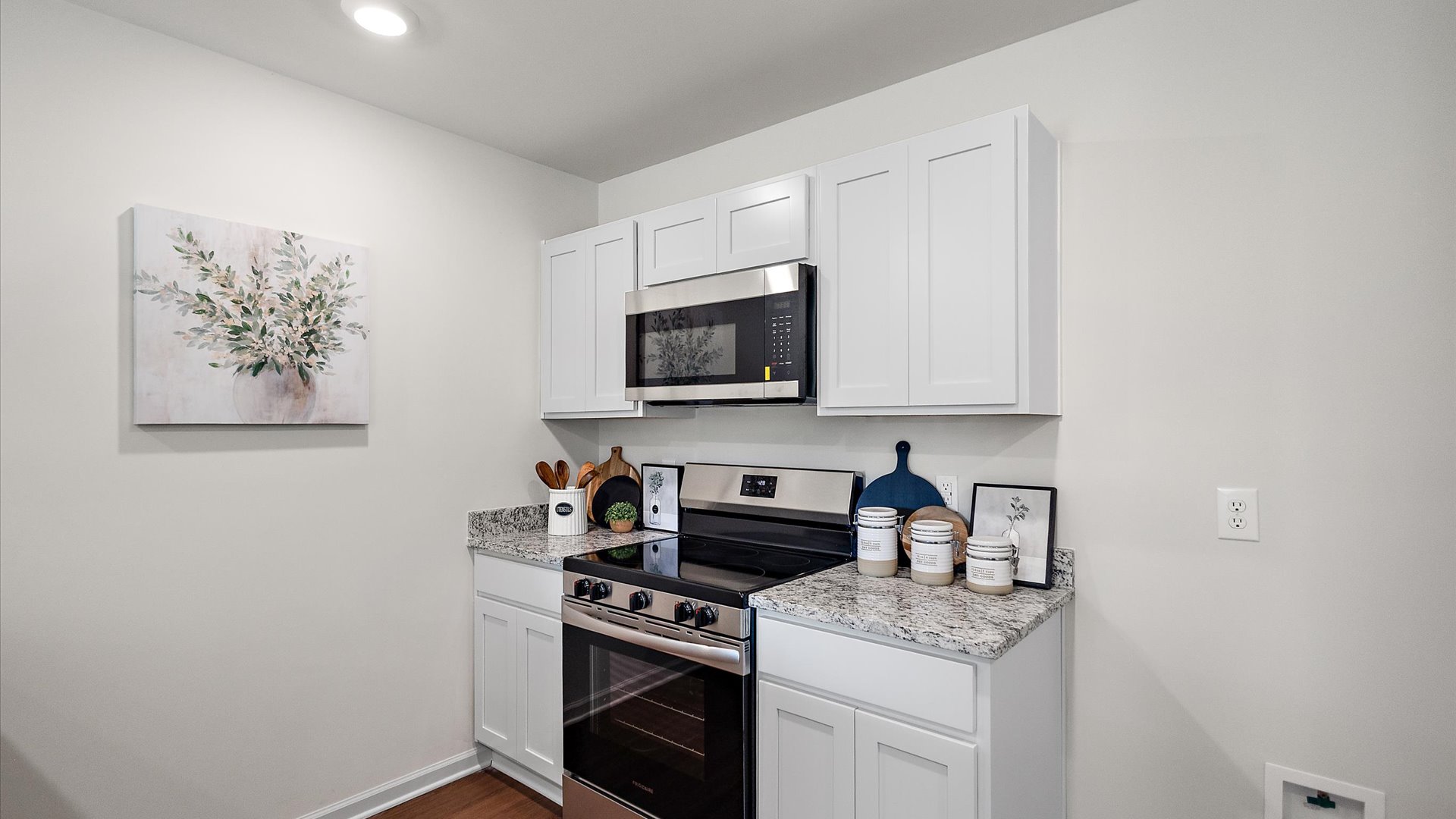 Kitchen with stainless steel appliances and shaker style cabinets