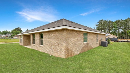 Back side exterior of the covered patio and side of the house.