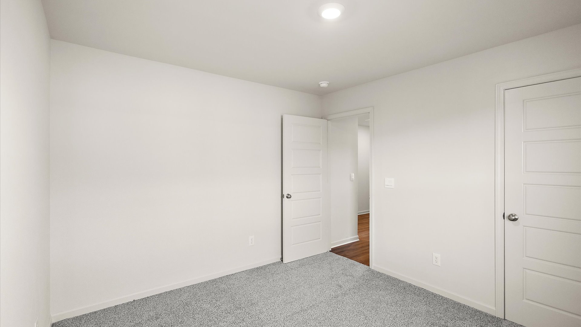 additional bedroom with carpeted floors and window for natural light