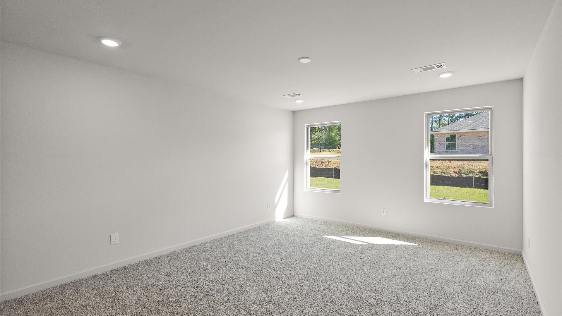 primary bedroom with carpet and recessed lighting