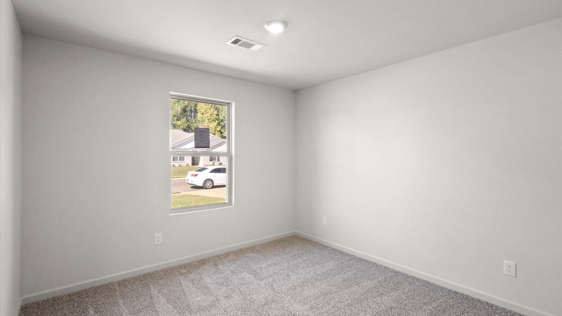 additional bedroom with carpeted floors and window