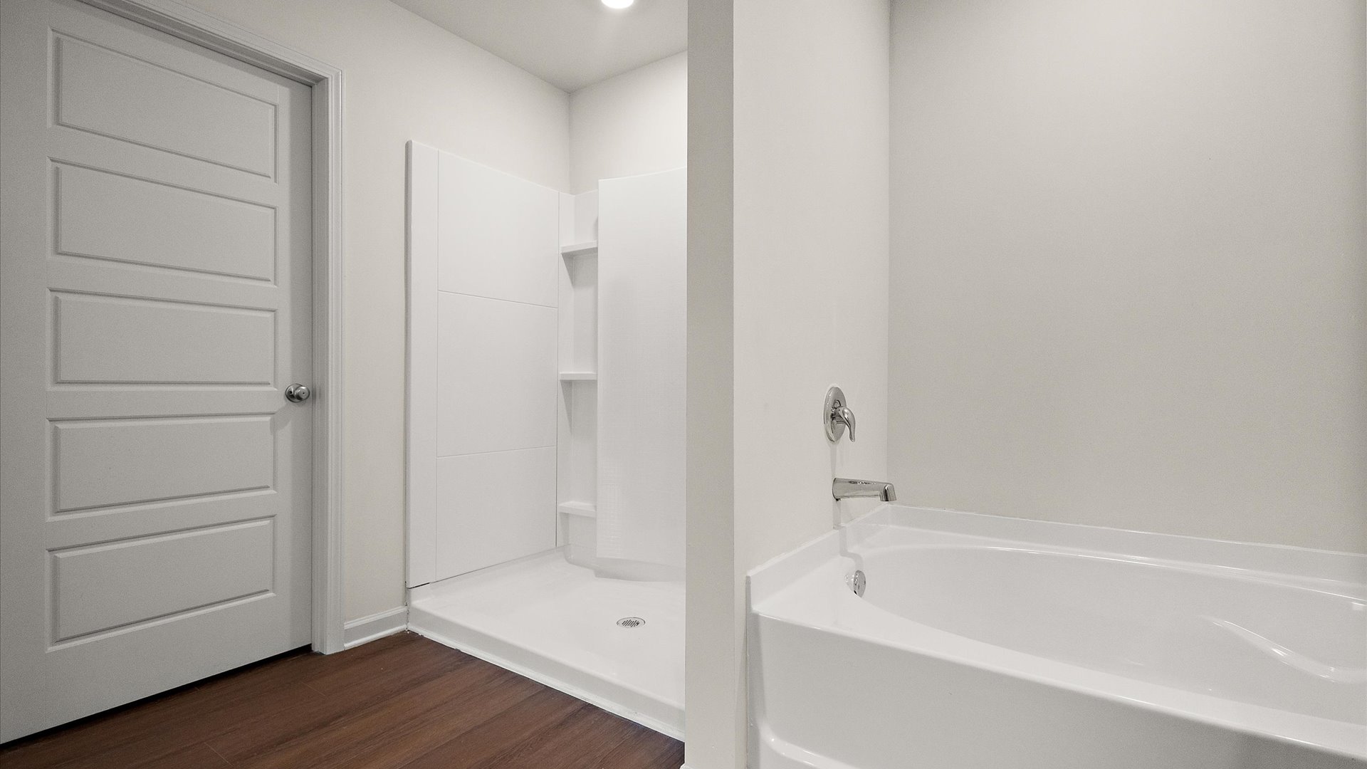 walk in shower with built in shelving and garden tub