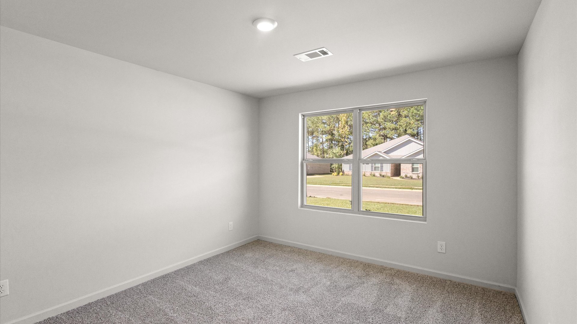additional bedroom with carpeted floors and window