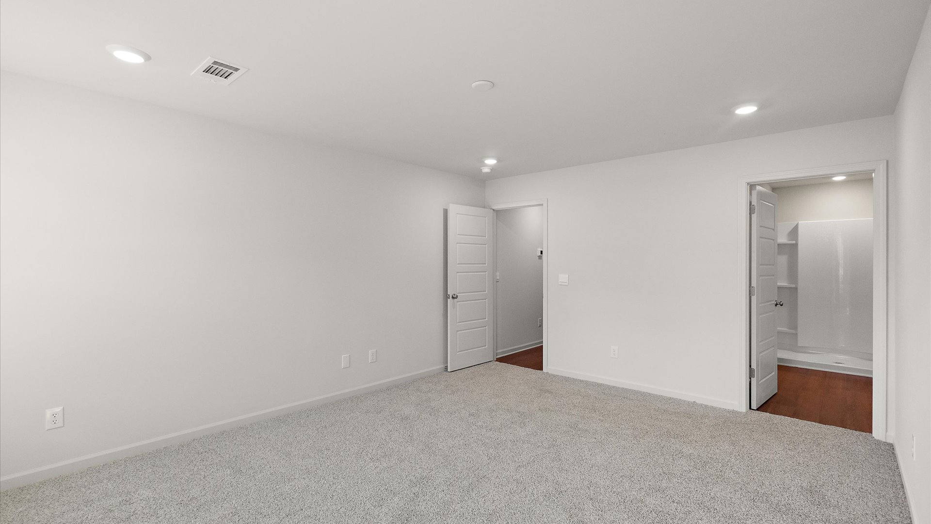 primary bedroom with carpet and recessed lighting
