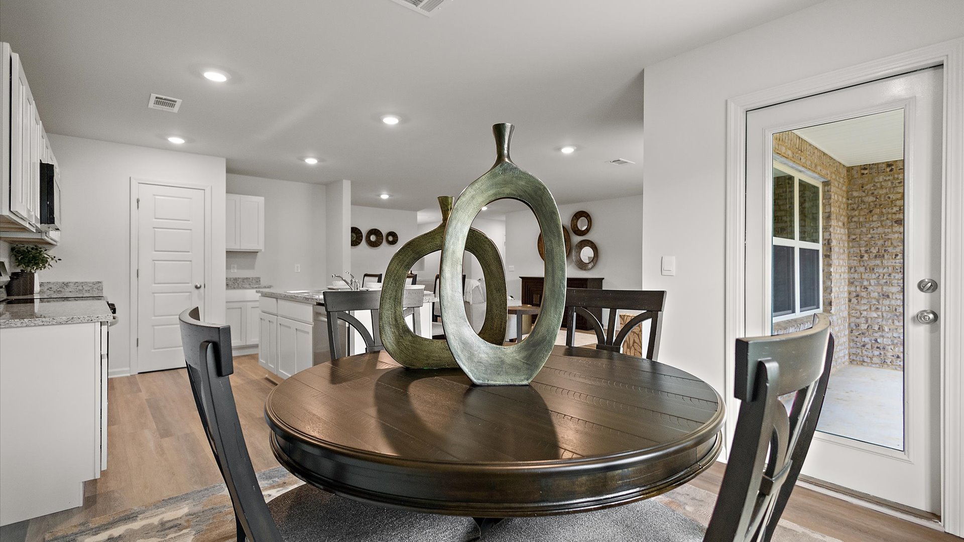 Open concept dining area with large glass door leading to back patio.