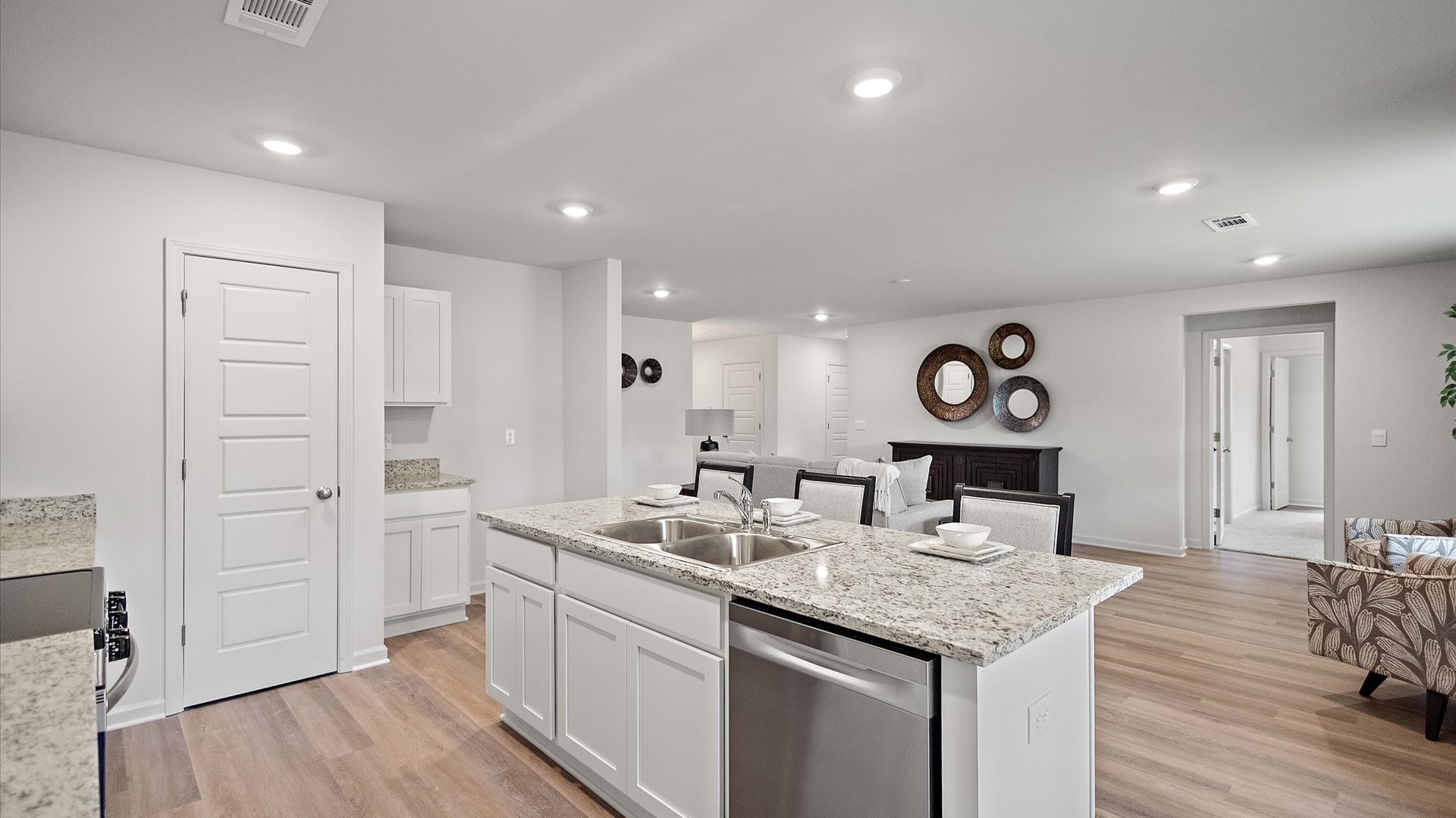 Open concept kitchen with living area behind.