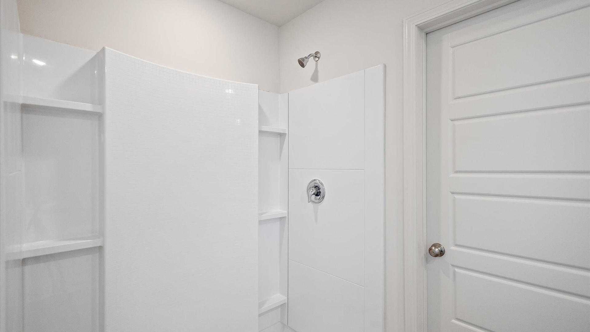 Walk in shower with while tile.