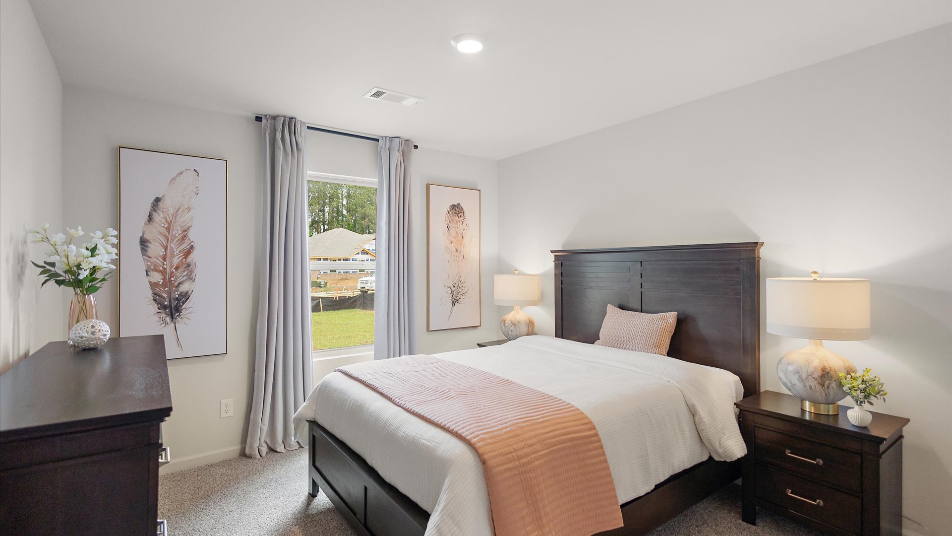 Bedroom three with carpeted floors and windows for natural light.