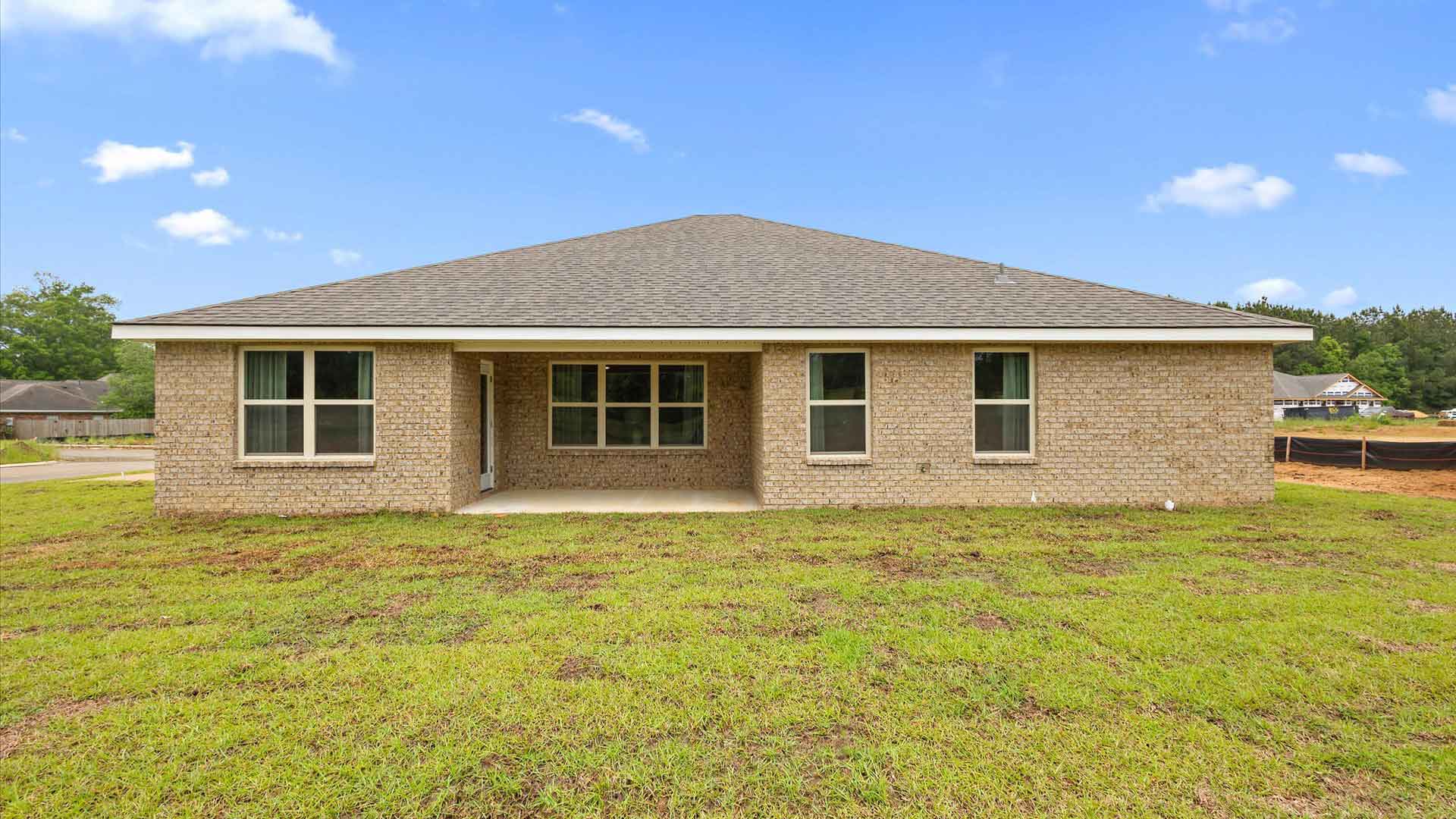 Back exterior of the covered patio opening up the backyard.