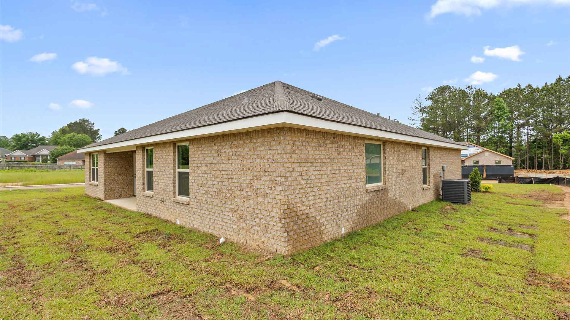 Back side exterior of the covered patio and side of the house.