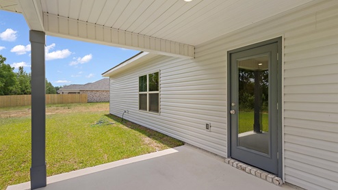rear exterior of home featuring a covered concrete patio