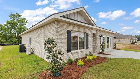 The single story freeport has a covered entry area and driveway.