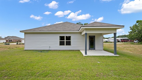 rear exterior of home featuring a covered concrete patio