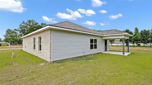 rear exterior of home featuring a covered concrete patio