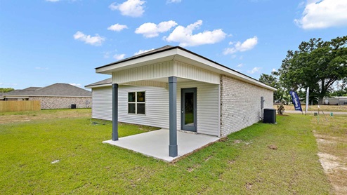 rear exterior of home featuring a covered concrete patio