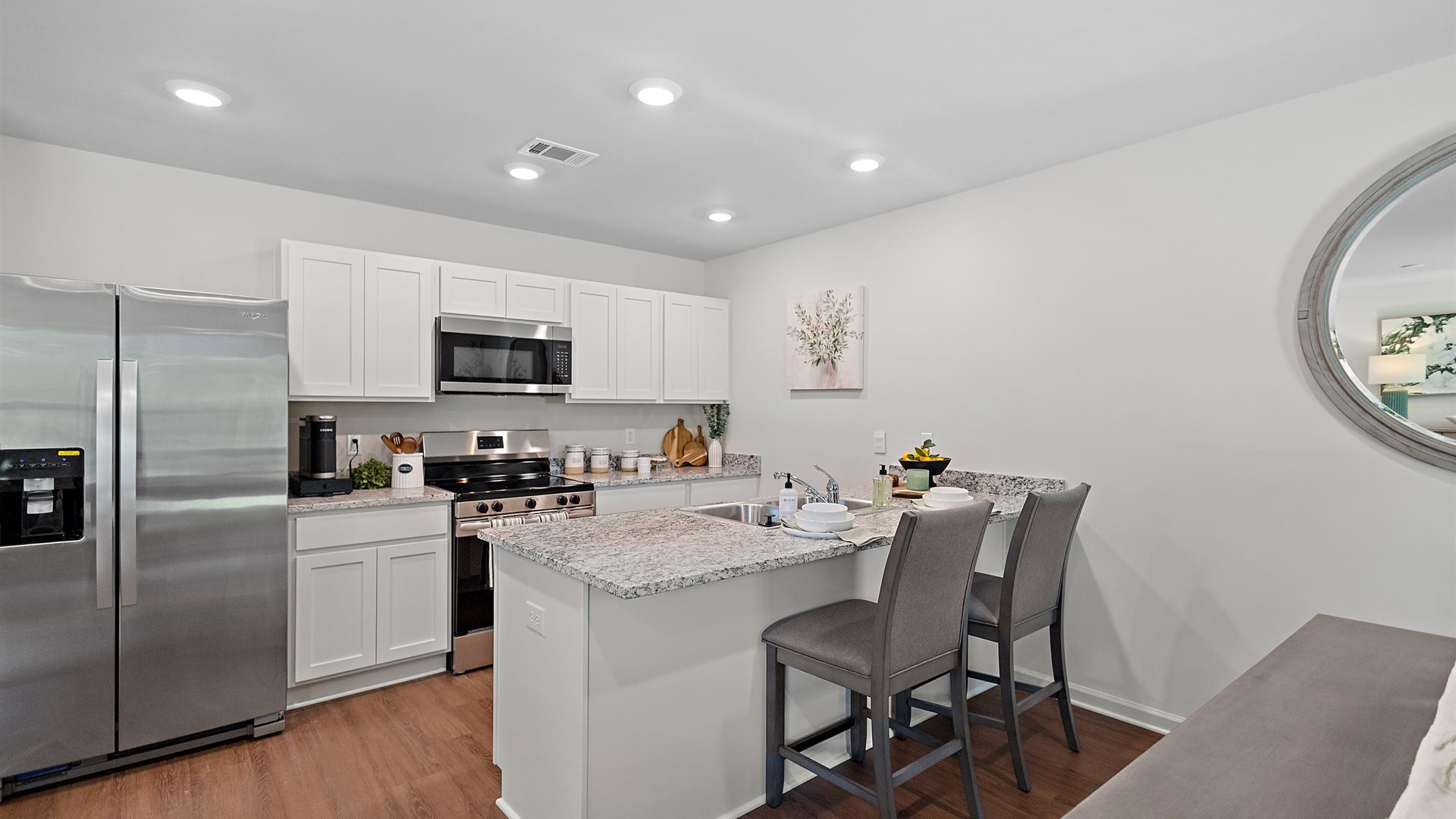 kitchen with white cabinetry, large island and stainless steel appliances