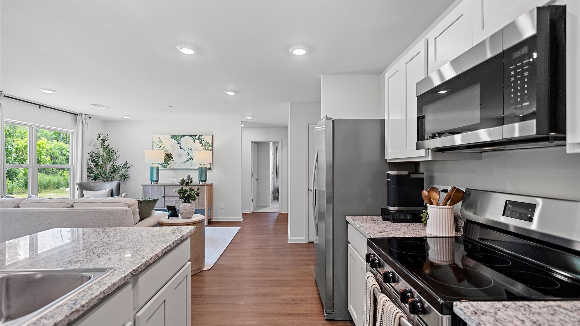 kitchen with white cabinetry, large island and stainless steel appliances