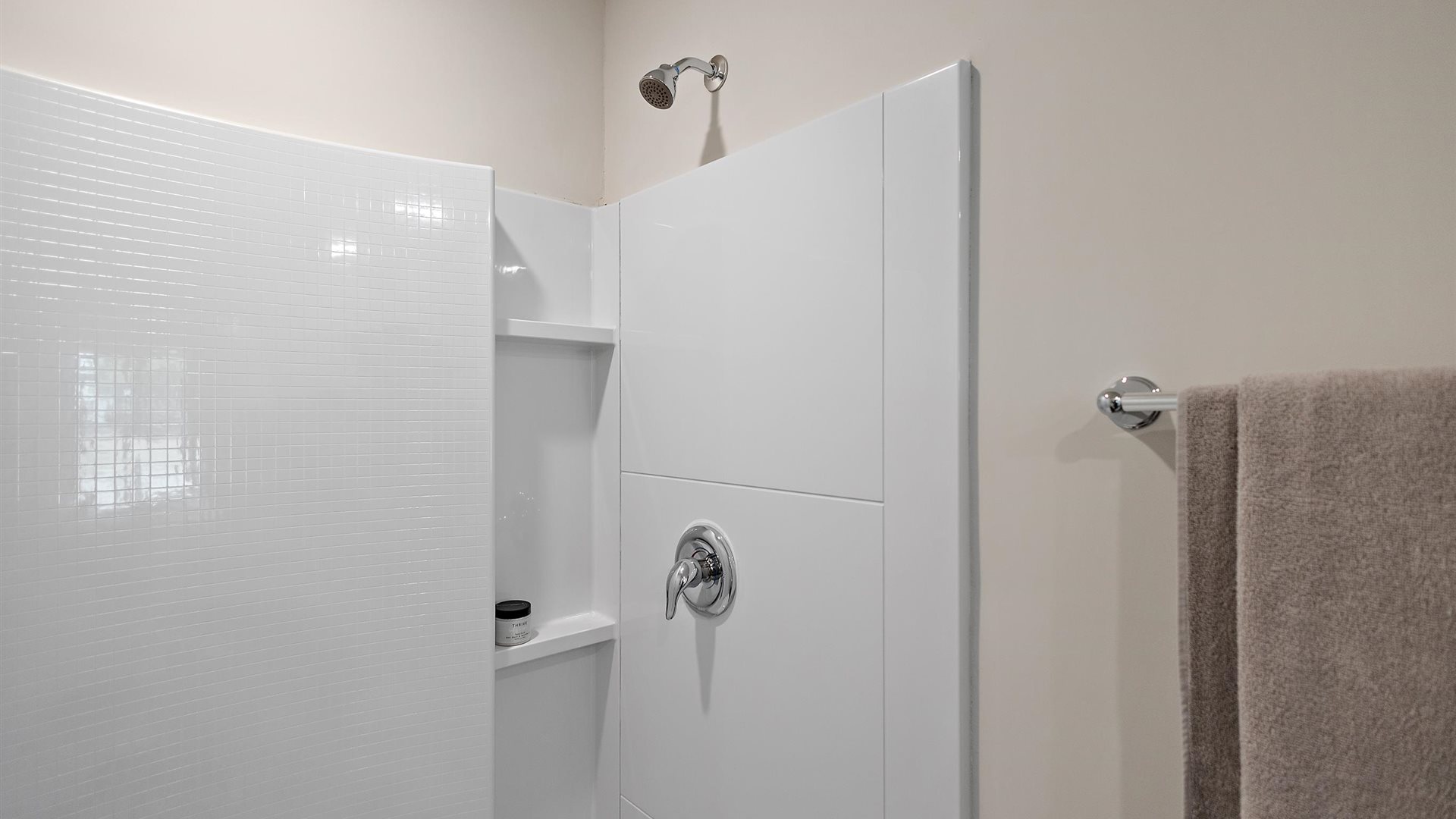 white tiled walk in shower