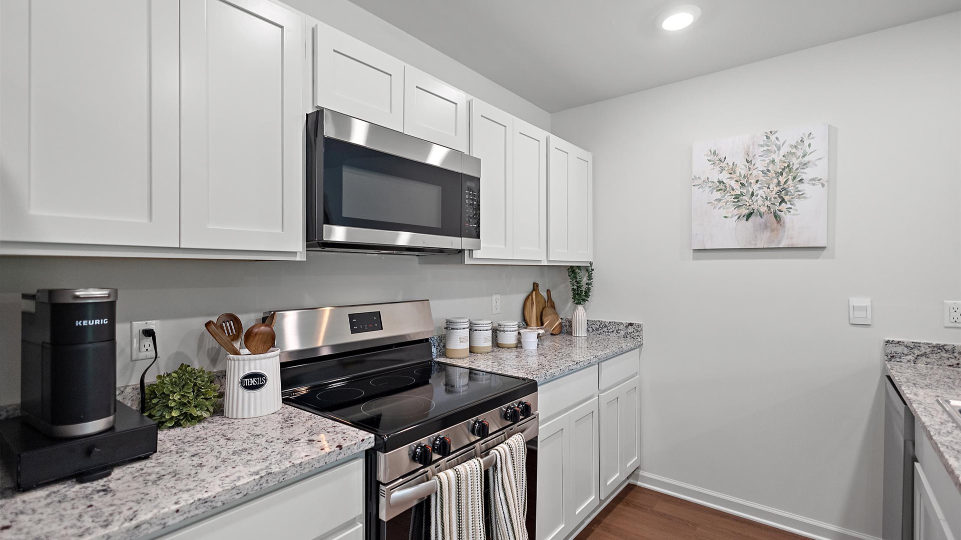 kitchen with white cabinetry, large island and stainless steel appliances