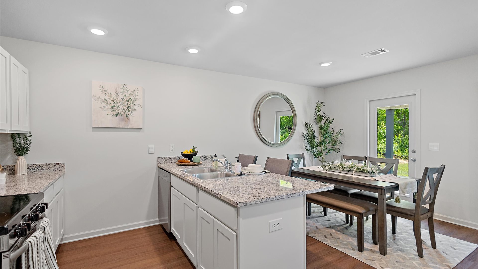 kitchen with white cabinetry, large island and stainless steel appliances