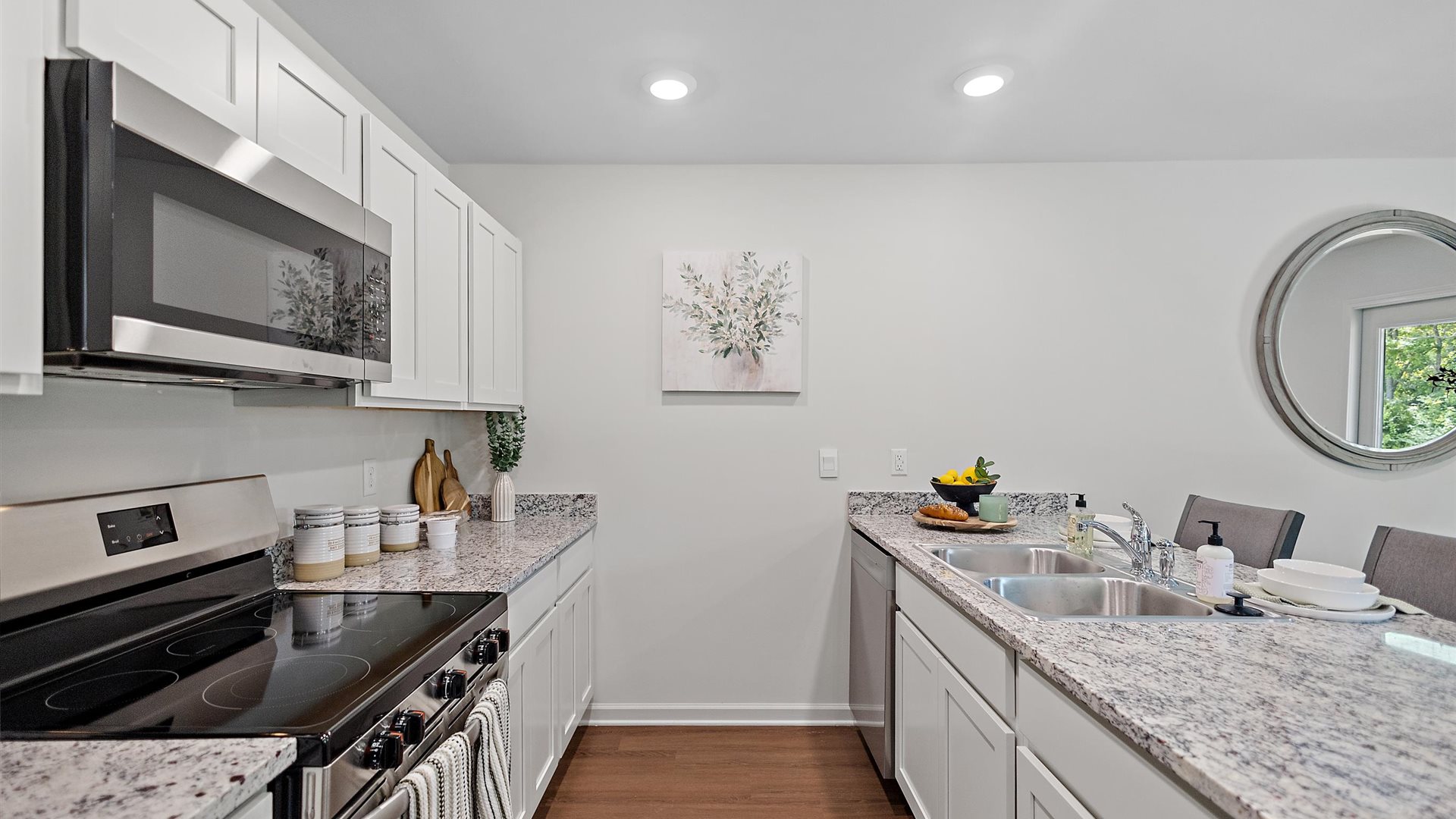 kitchen with white cabinetry, large island and stainless steel appliances