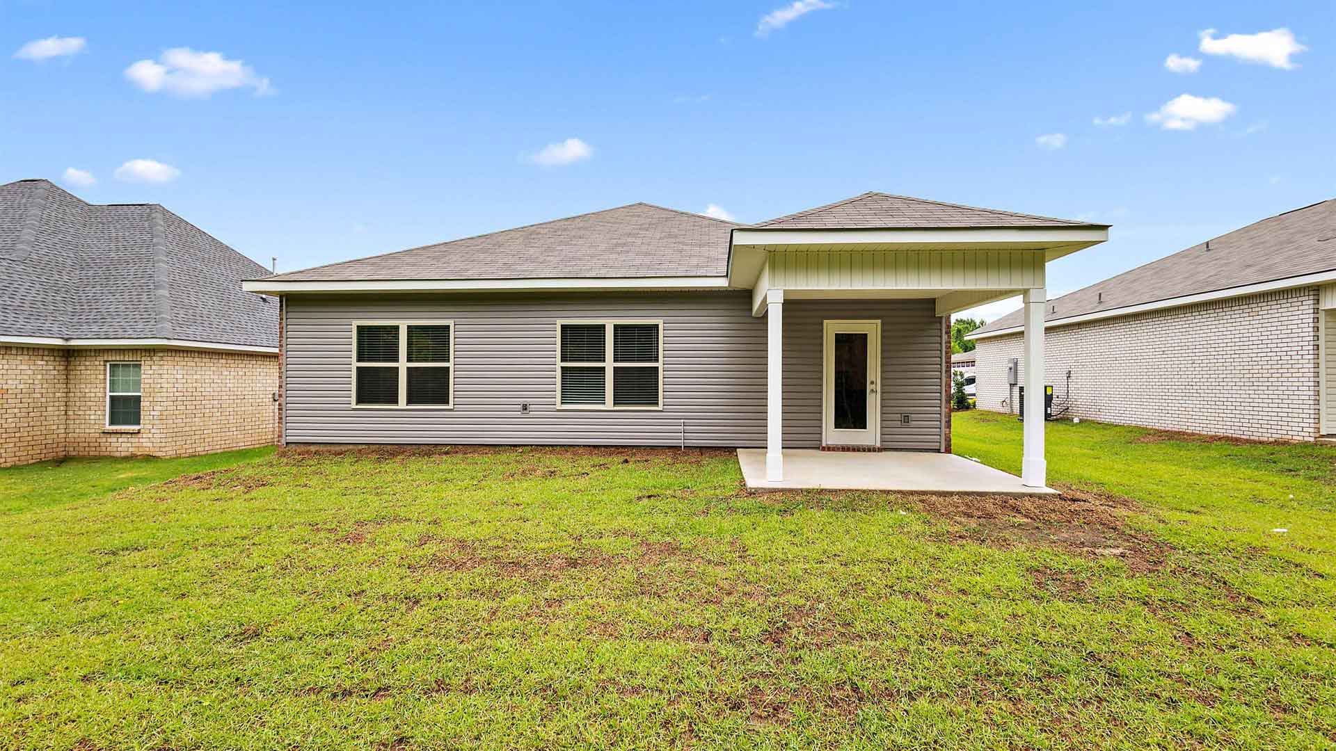 Back exterior of the covered patio opening up the backyard.