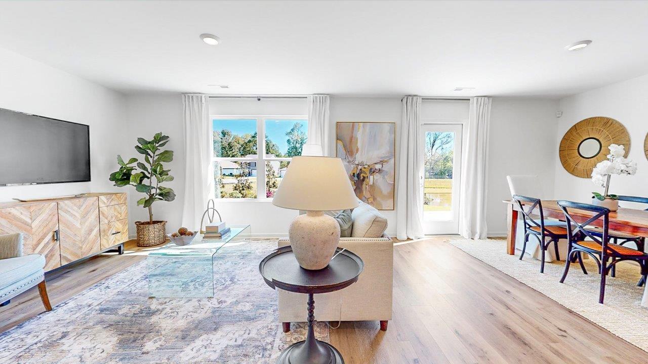 A spacious living room that opens to the dining room.