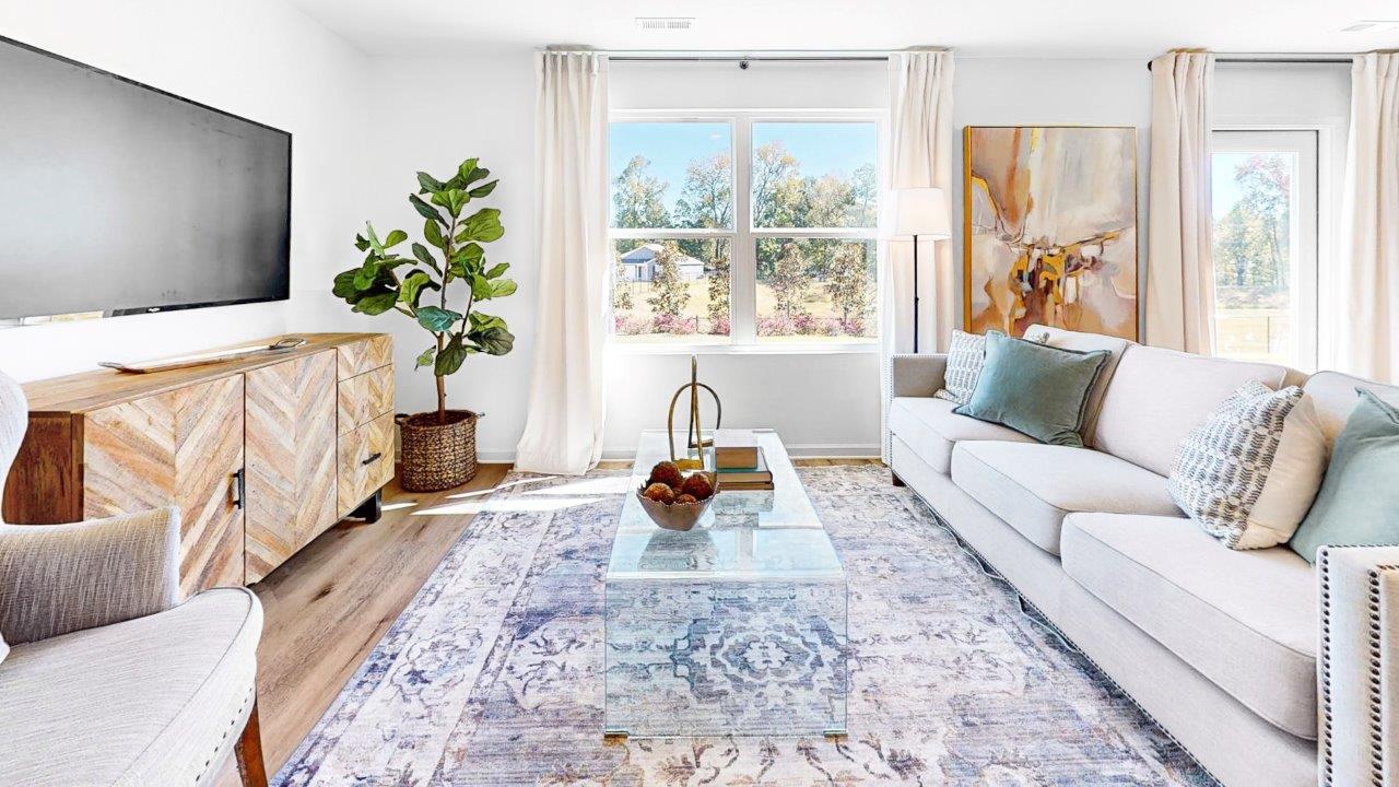 A spacious living room that opens to the dining room.
