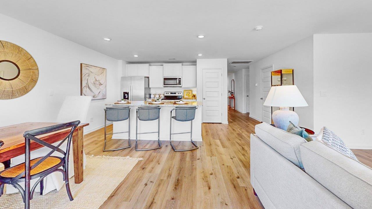 A chef inspired kitchen that features a pantry, stainless steel appliances, and a large kitchen island.