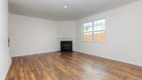 Open family room with fireplace and large window