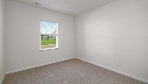 carpeted bedroom with one small window