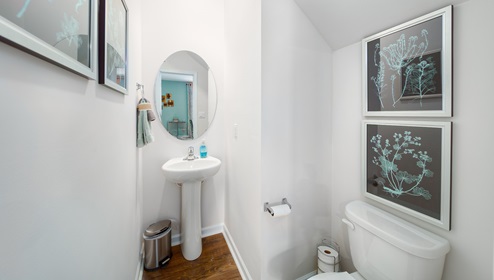 Powder bathroom with small white sink and toilet