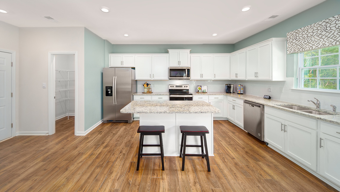 Kitchen and island with white cabinets and counters